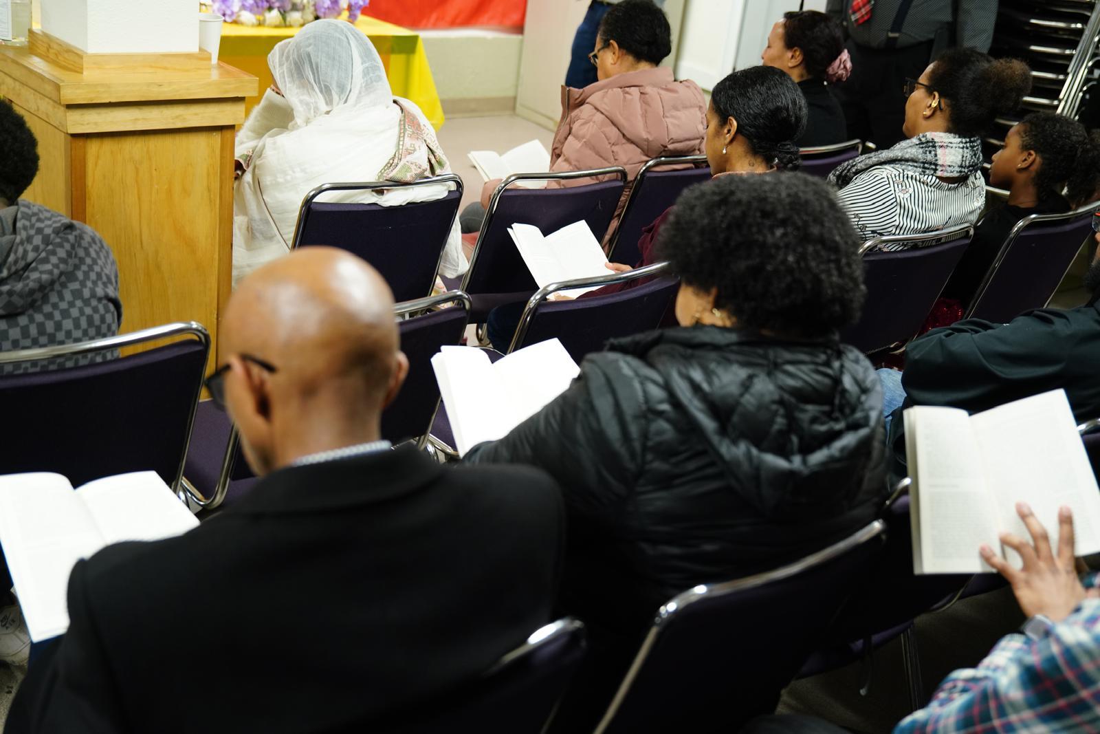 Audience following along during a community book reading